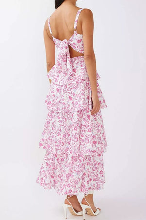 Maxi dress with pink floral print, tie-back detail, and tiered skirt.