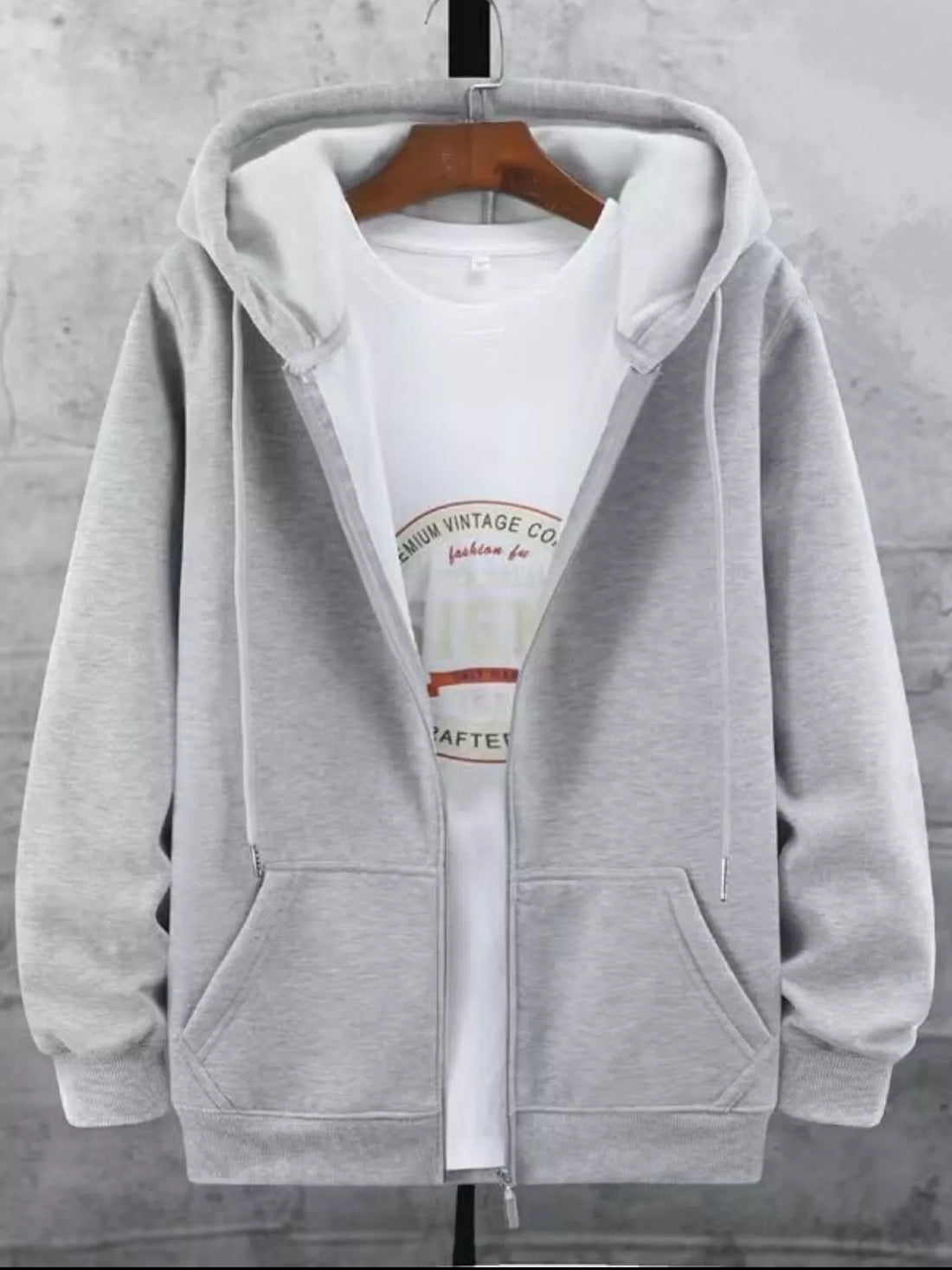 Gray fleece-lined zip-up hoodie with a white graphic t-shirt underneath.