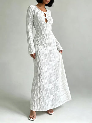 White textured long sleeve maxi dress with cutout detail and figure-hugging silhouette.