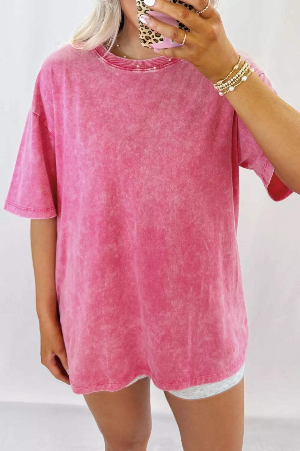 Vibrant pink mineral-washed relaxed fit cotton t-shirt with pearl neckline detail.