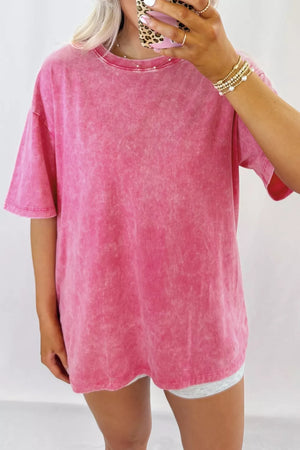Vibrant pink mineral-washed relaxed fit cotton t-shirt with pearl neckline detail.