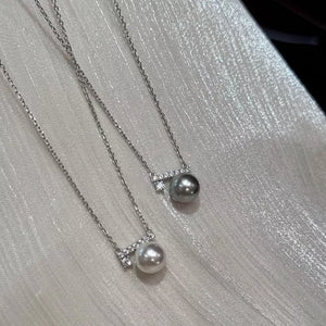 Lustrous pearl pendant necklaces with zircon accents in light gray and cream.