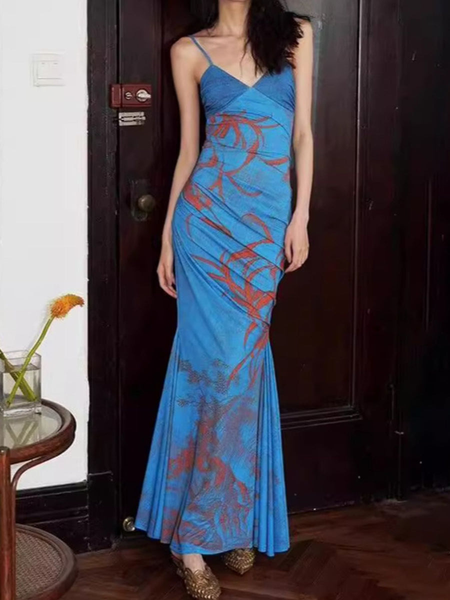 Blue spaghetti strap maxi dress with botanical print and ruched side detail.