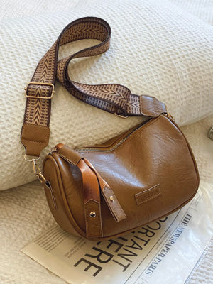 Brown retro shoulder crossbody bag with patterned strap and "FASHION" detail.