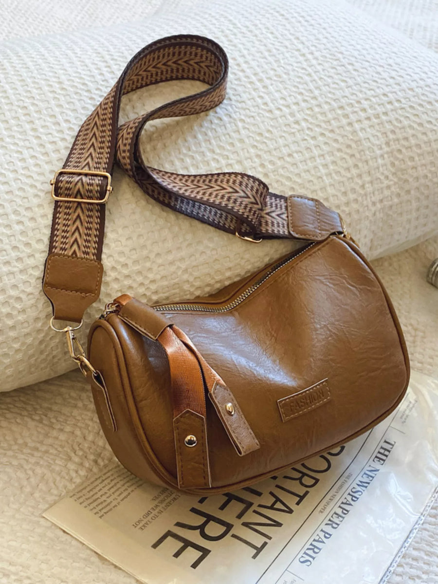 Brown retro shoulder crossbody bag with patterned strap and "FASHION" detail.
