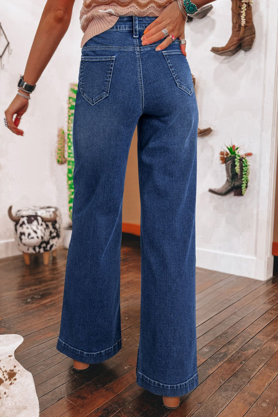 Medium wash denim wide leg jeans with buttoned fly and utility pockets.