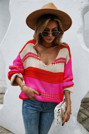 Deep Plunge Colorblock Knit Pullover in pink, red, and cream with v-neck and long sleeves.