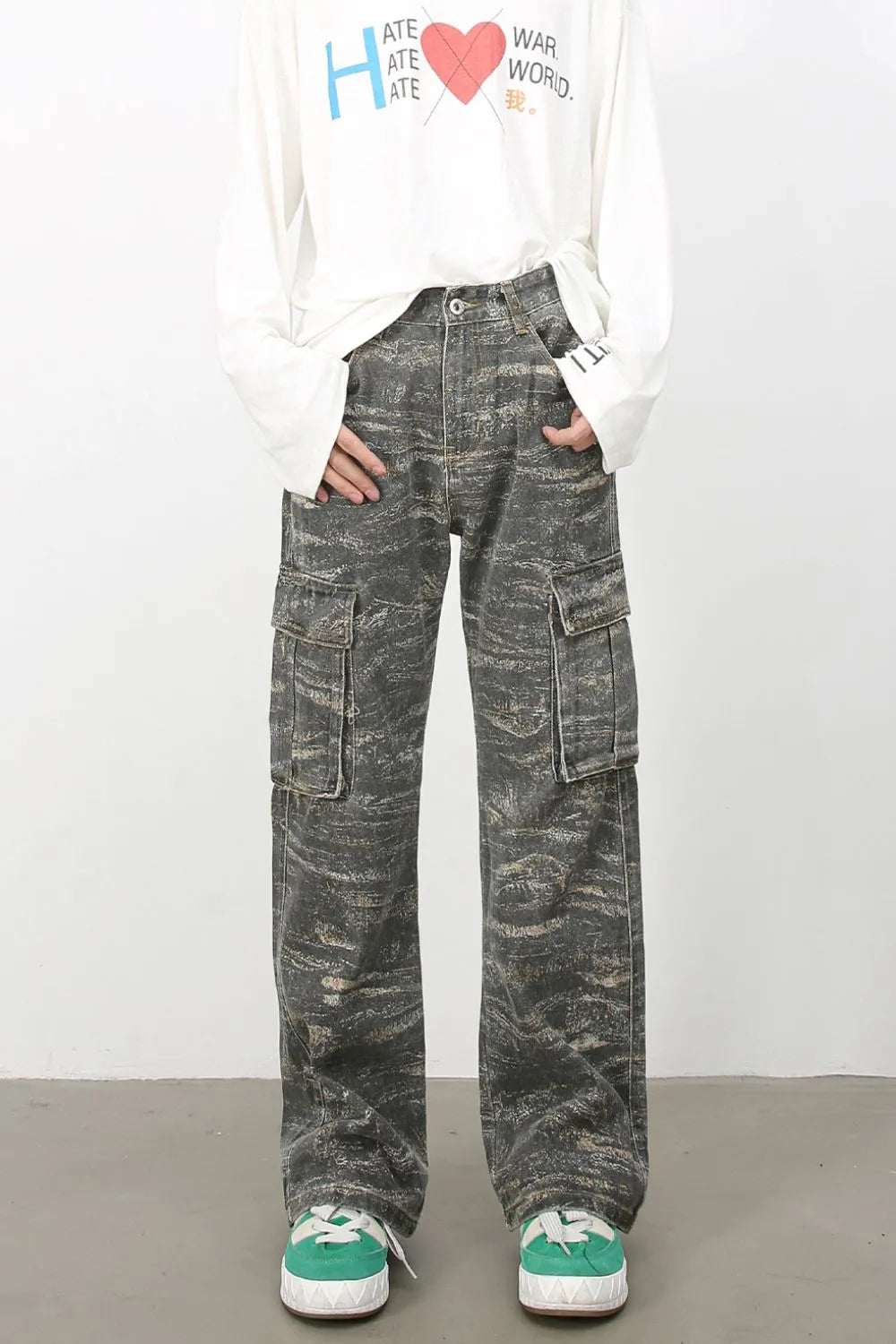 Distressed camo wide-leg cargo jeans in dark gray with multiple pockets.