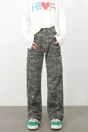 Distressed camo wide-leg cargo jeans in dark gray with multiple pockets.
