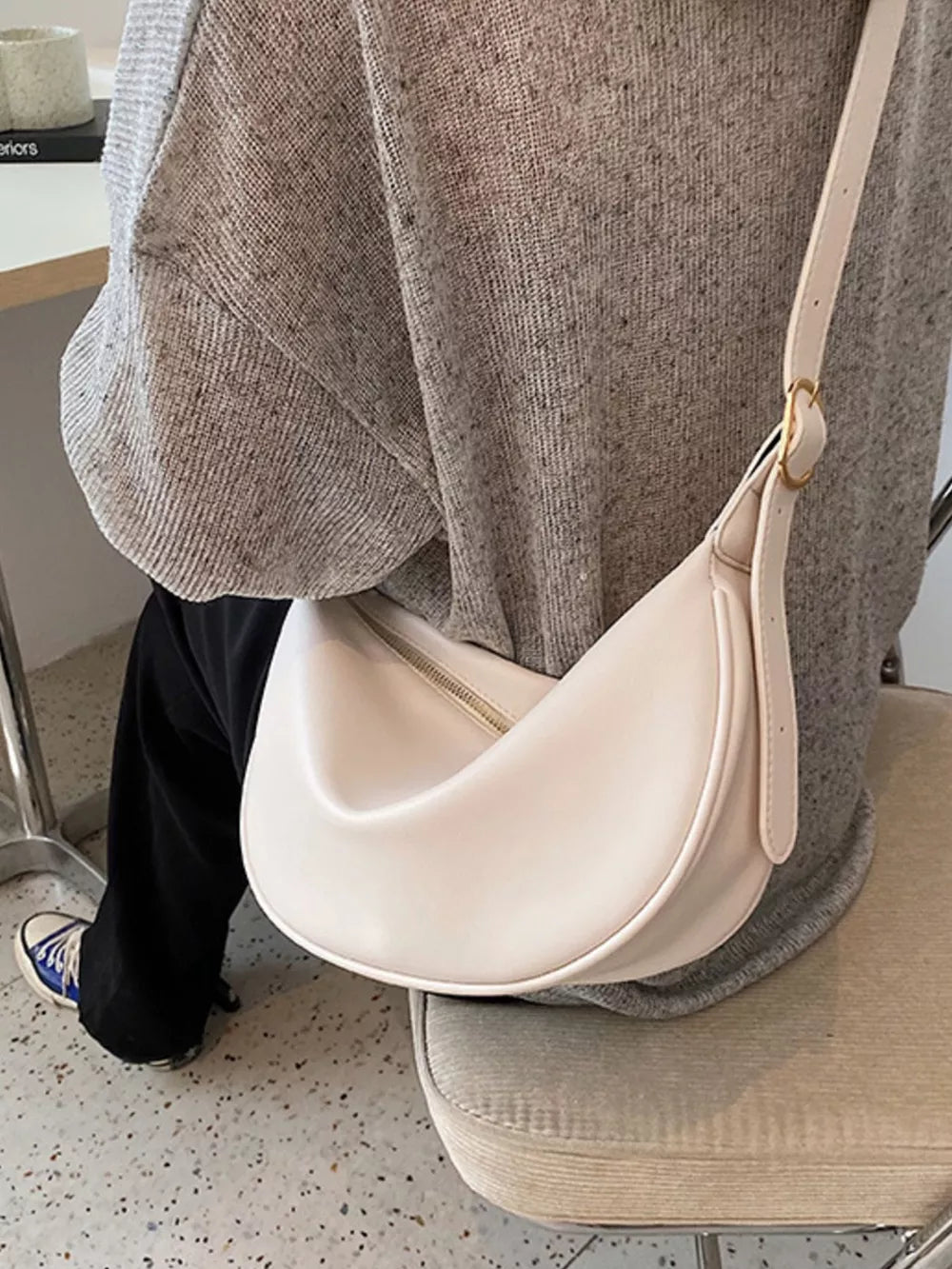 Minimalist white crescent crossbody bag with adjustable strap