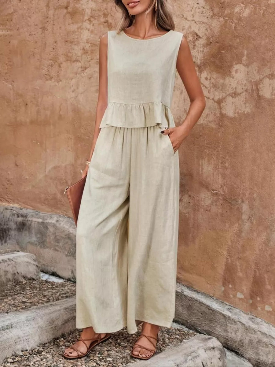 Beige ruffled peplum top and wide-leg pants set with round neckline and sleeveless design.