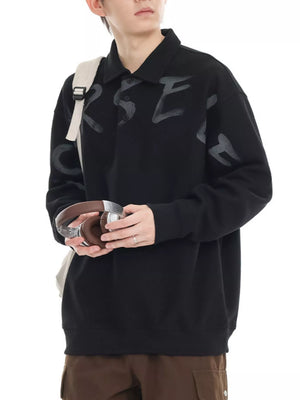 Black oversized polo sweatshirt with a graphic letter print and button neckline.