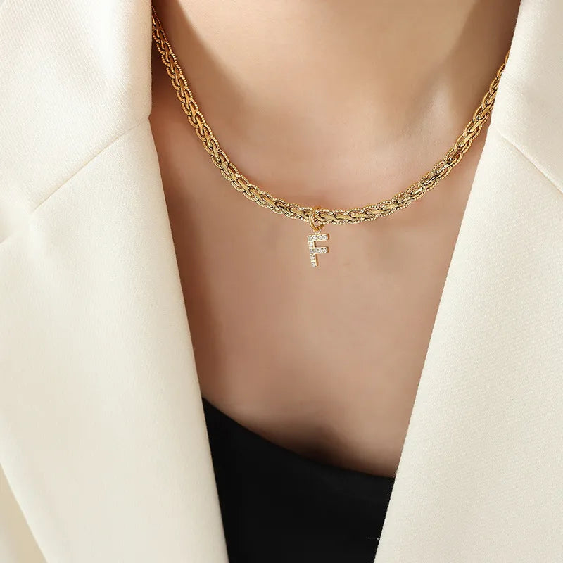 Gold chain necklace with a zircon-set initial F pendant, Style F