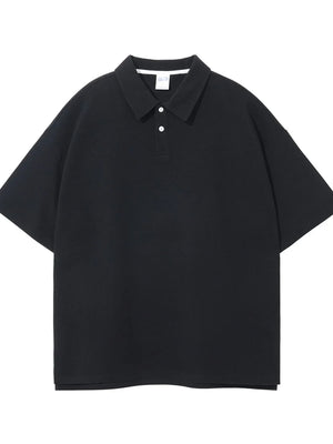 Black textured boxy polo shirt with short sleeves and a two-button placket.