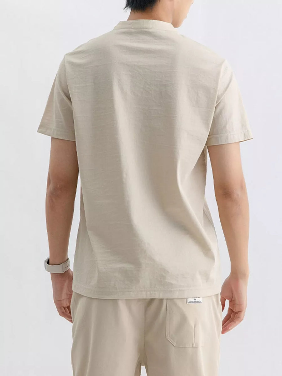 Men's short sleeve t-shirt in apricot with a mandarin collar.