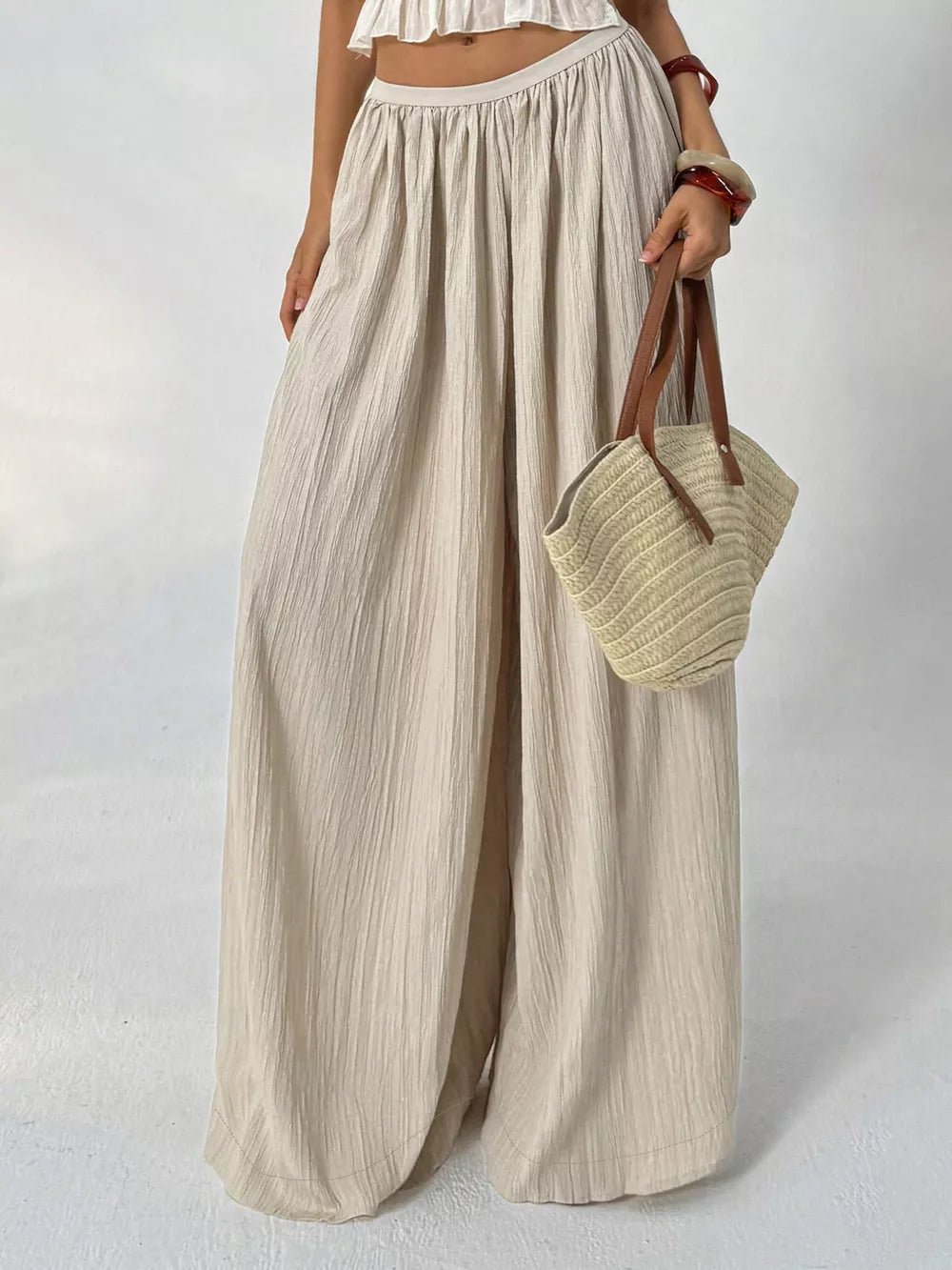 Textured beige maternity pants with wide legs and gathered waist