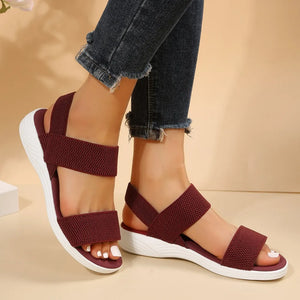 Burgundy knit strap sandals with white soles and elastic bands.
