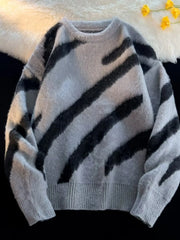 Oversized fuzzy knit pullover sweater in grey with black abstract stripes.