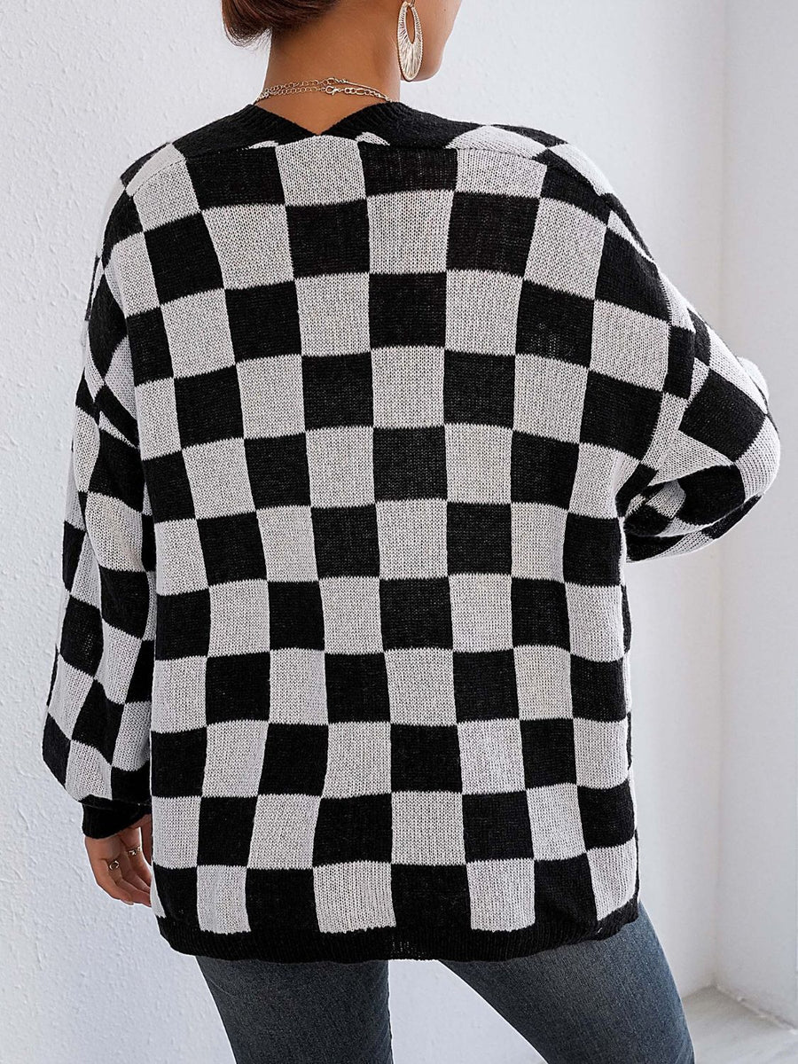 Checkerboard knit cardigan in black and white with balloon sleeves.