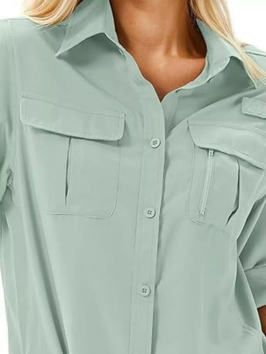 Sage button up shirt with two chest pockets, one with a zipper detail.