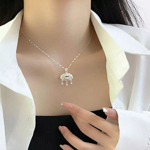 Silver necklace featuring pendant and ornate