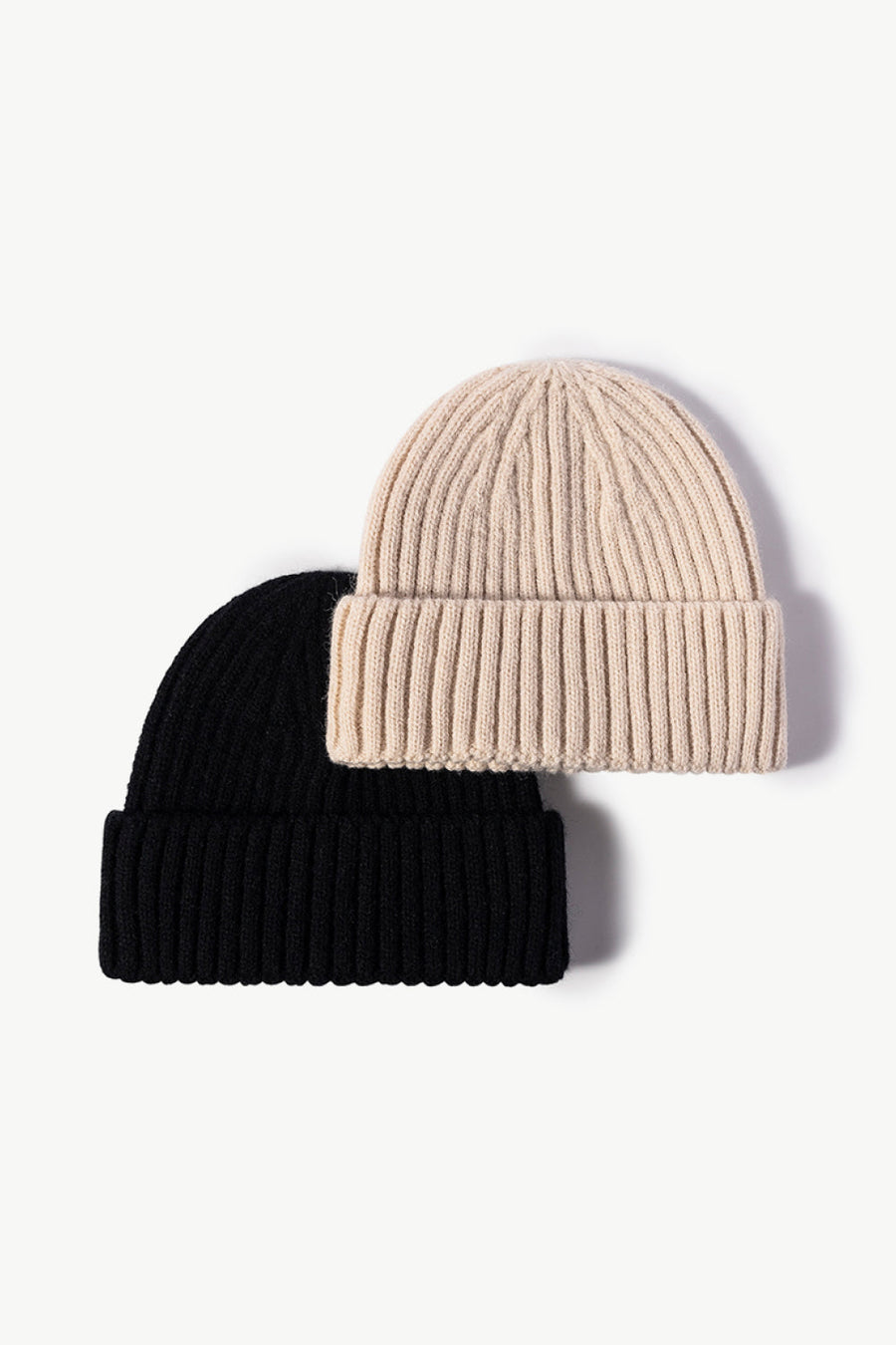 Chunky ribbed knit beanies in black and cream acrylic.