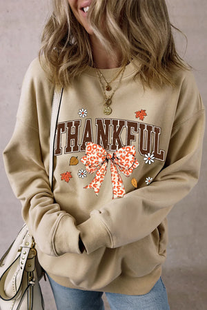 Khaki graphic sweatshirt with "THANKFUL" text and a leopard print bow.