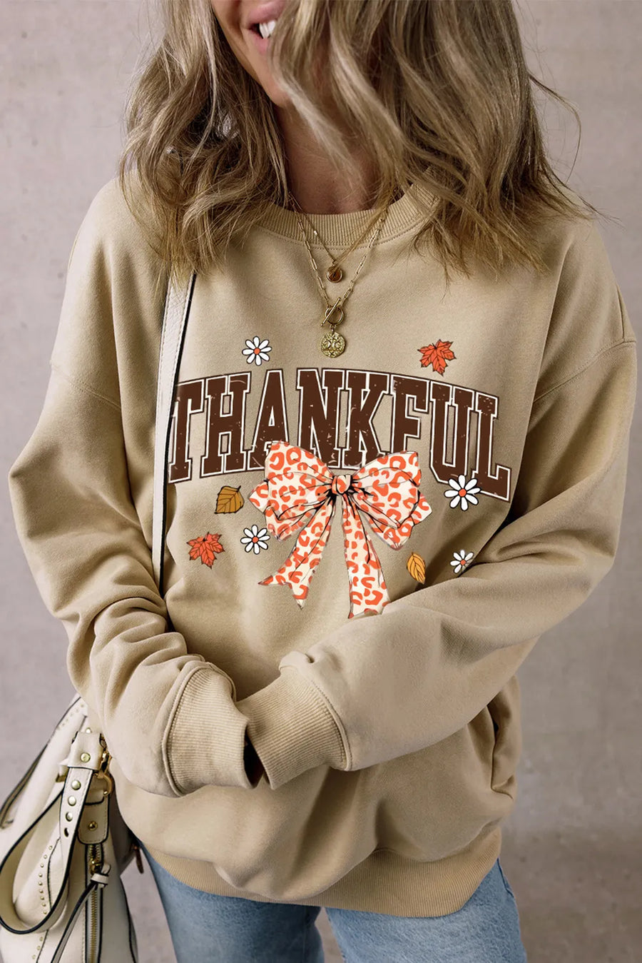 Khaki graphic sweatshirt with "THANKFUL" text and a leopard print bow.