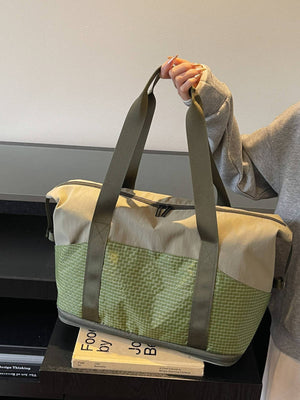Spacious nylon travel duffel bag in khaki and green with grid pattern and dual handles.
