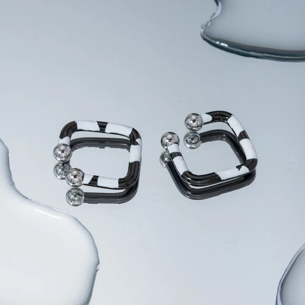 Geometric zebra stripe ear cuffs with silver ball details