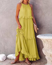 Yellow ruffled maxi dress with halter neck and tiered skirt.