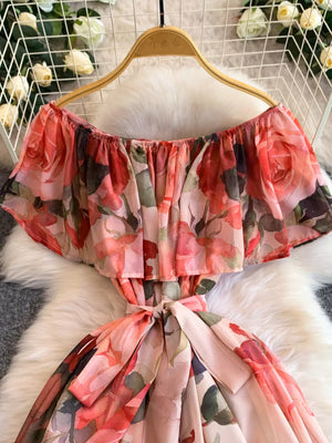 Botanical off-shoulder A-line dress in light pink with floral print and belted waist.