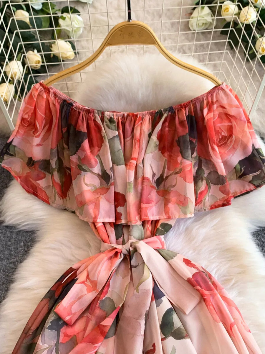 Botanical off-shoulder A-line dress in light pink with floral print and belted waist.