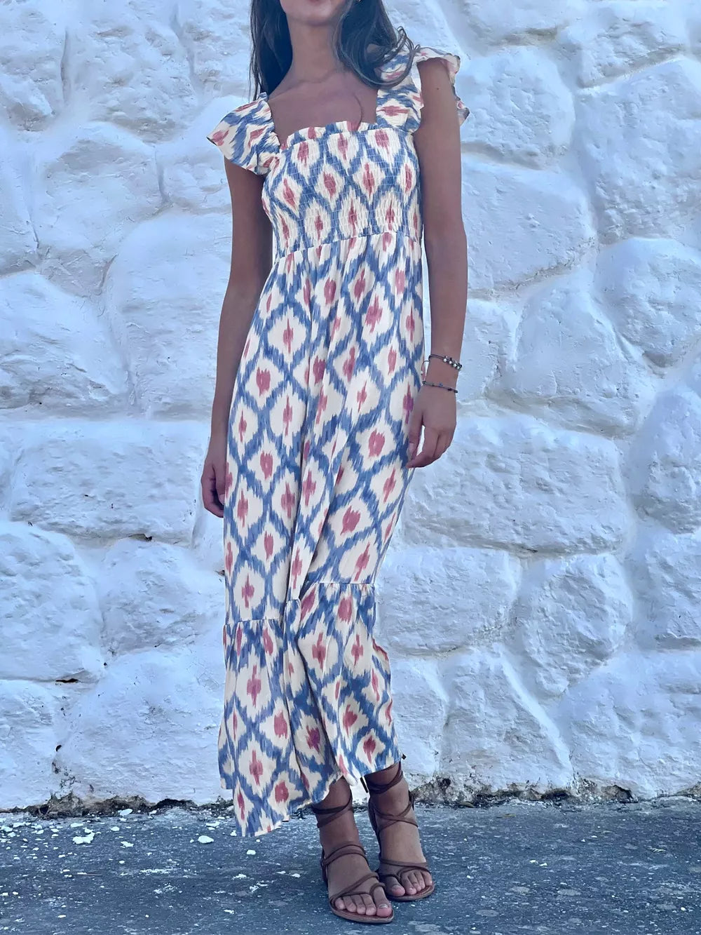 Smocked ruffle sleeve maxi dress with ikat pattern, square neck, and tiered hem.