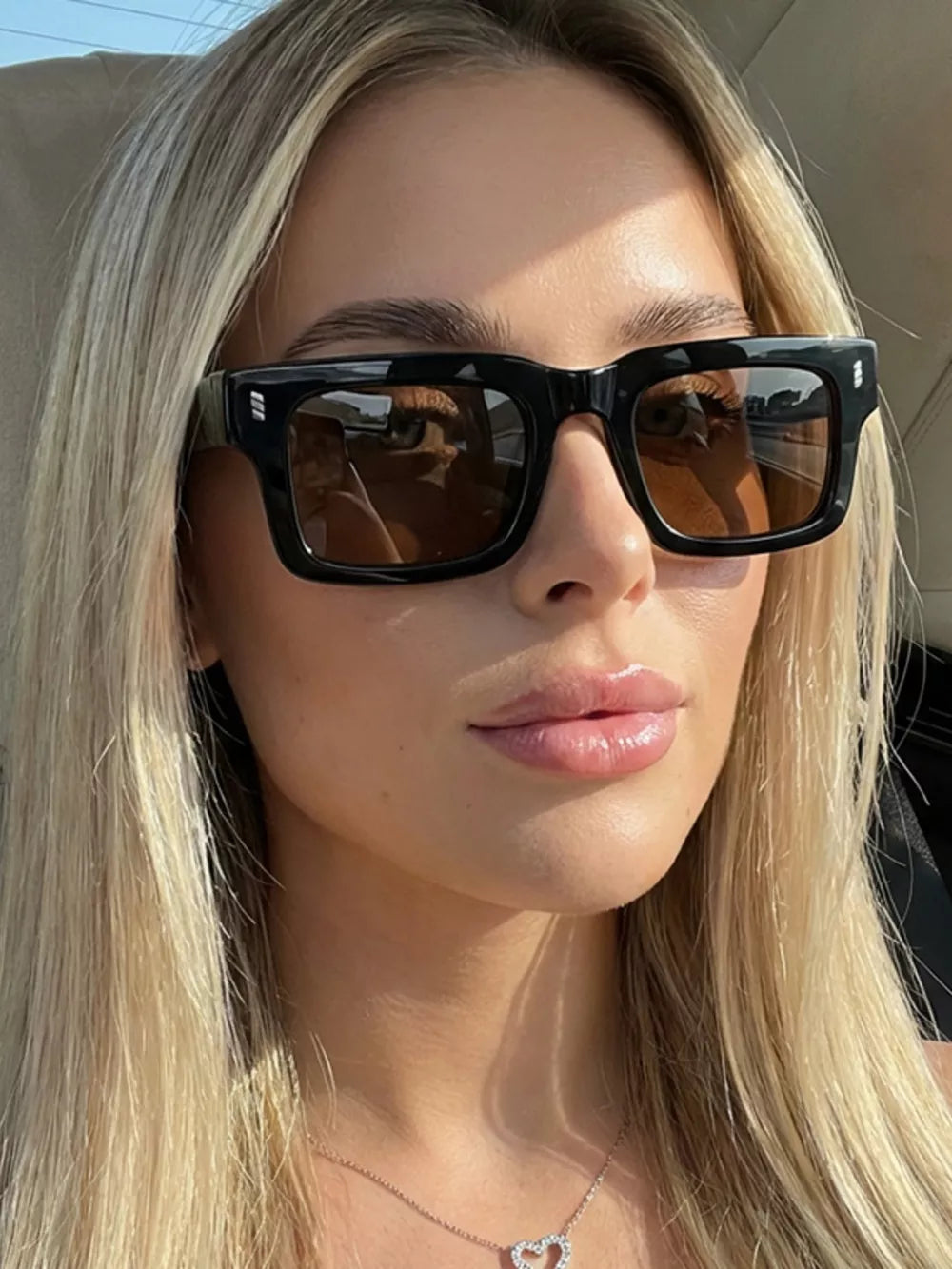 sunglasses in black featuring UV protection and rectangular fit