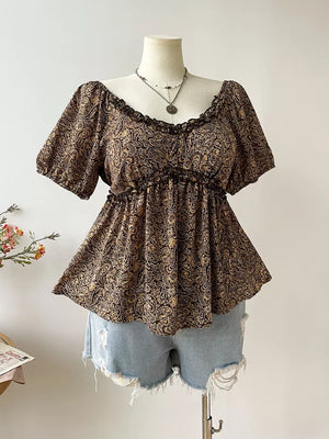Plus size coffee brown paisley print peasant blouse with ruffled neckline and short sleeves.