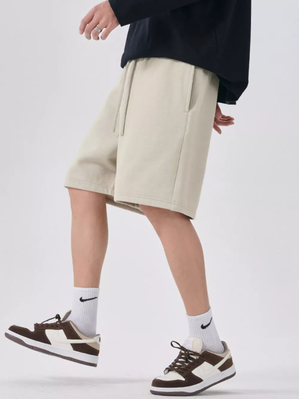 Beige chino shorts with drawstring waist and side pockets, relaxed fit.