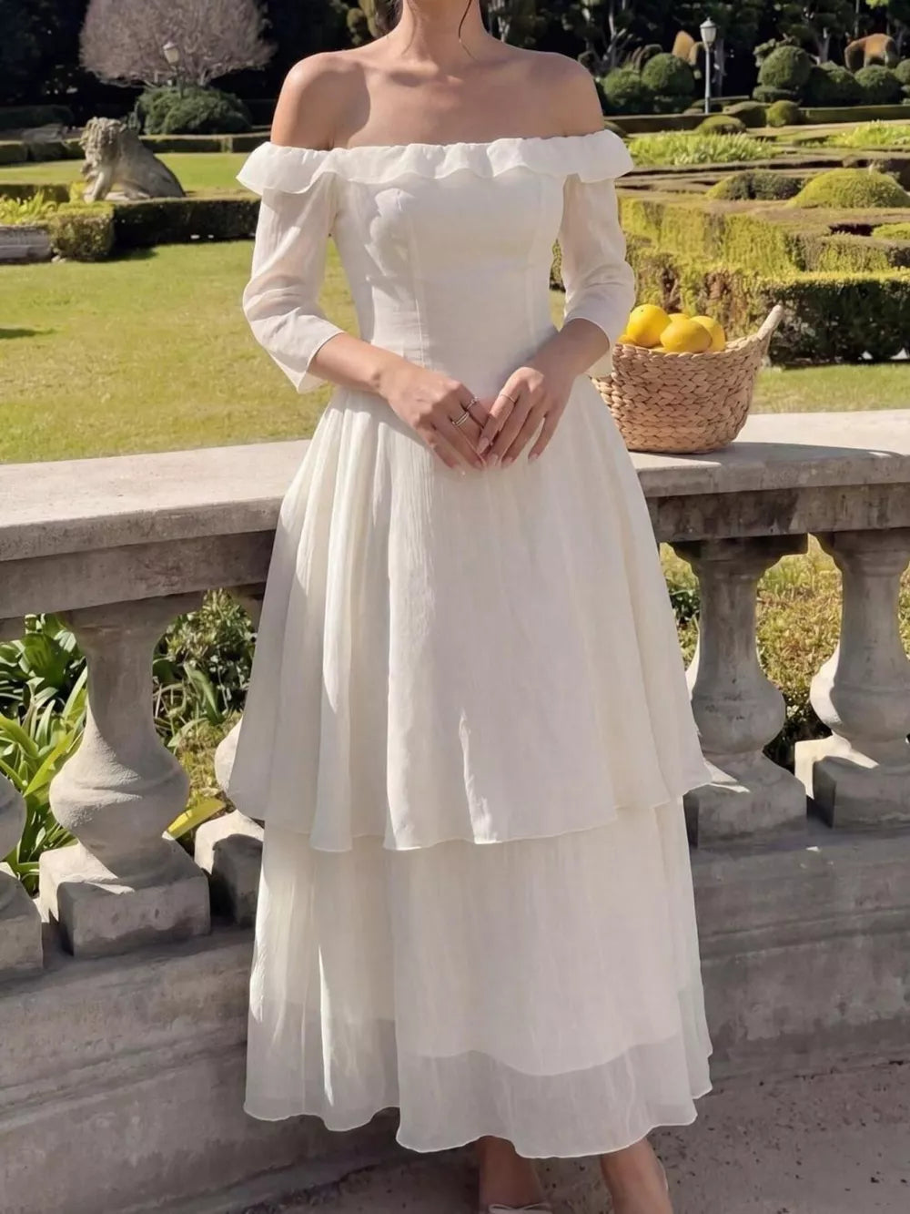 Elegant cream off-shoulder midi dress with ruffled neckline and tiered skirt