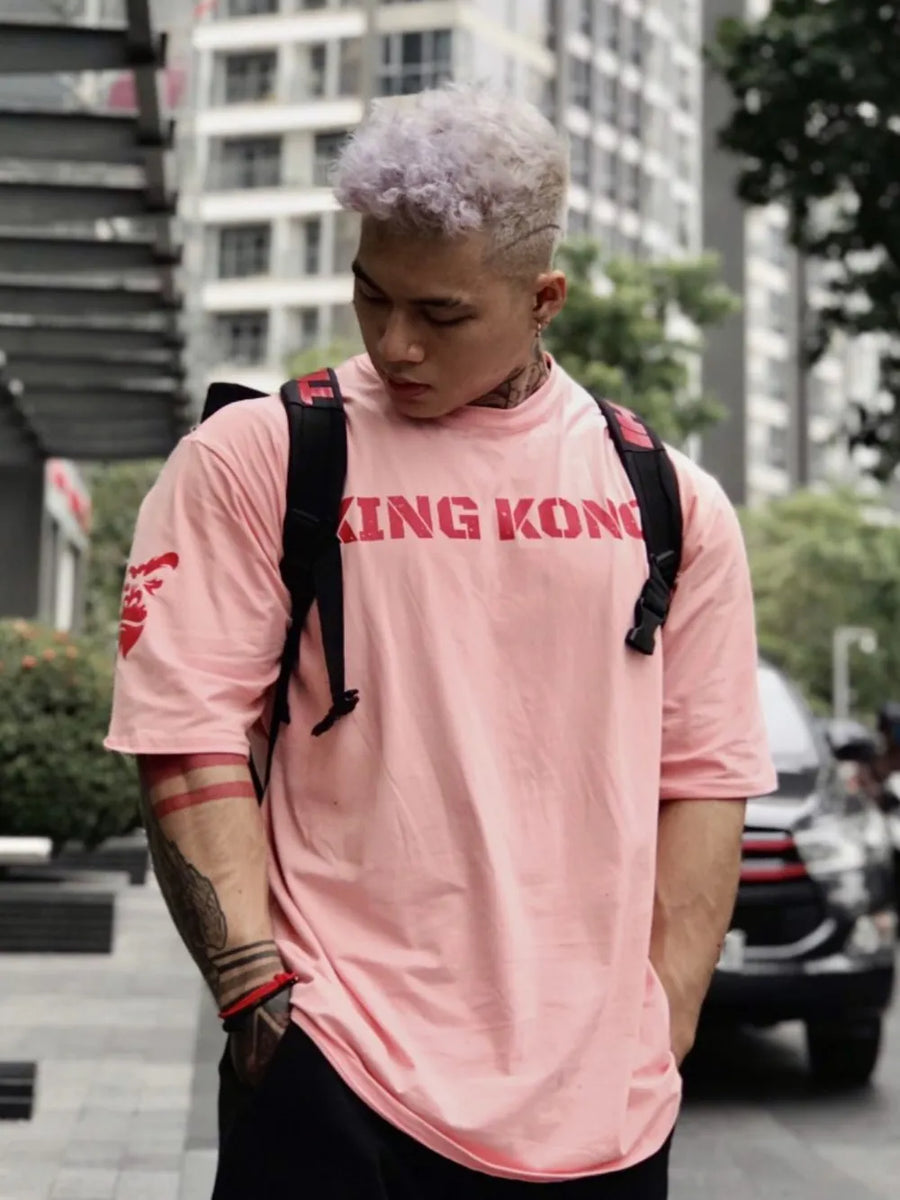 Dusty Pink oversized graphic tee with red King Kong text and sleeve detail.