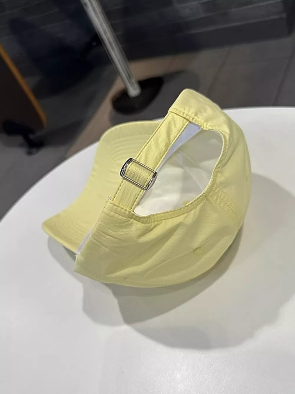 Yellow baseball cap with adjustable strap and metal buckle