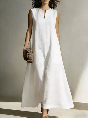 White linen maxi dress with V-neck, sleeveless, and pockets.
