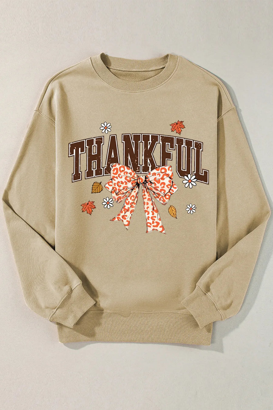 Khaki sweatshirt with "THANKFUL" graphic, leopard print bow, and fall leaves.