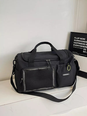 Black duffel bag with mesh pocket and yellow zipper pull detail
