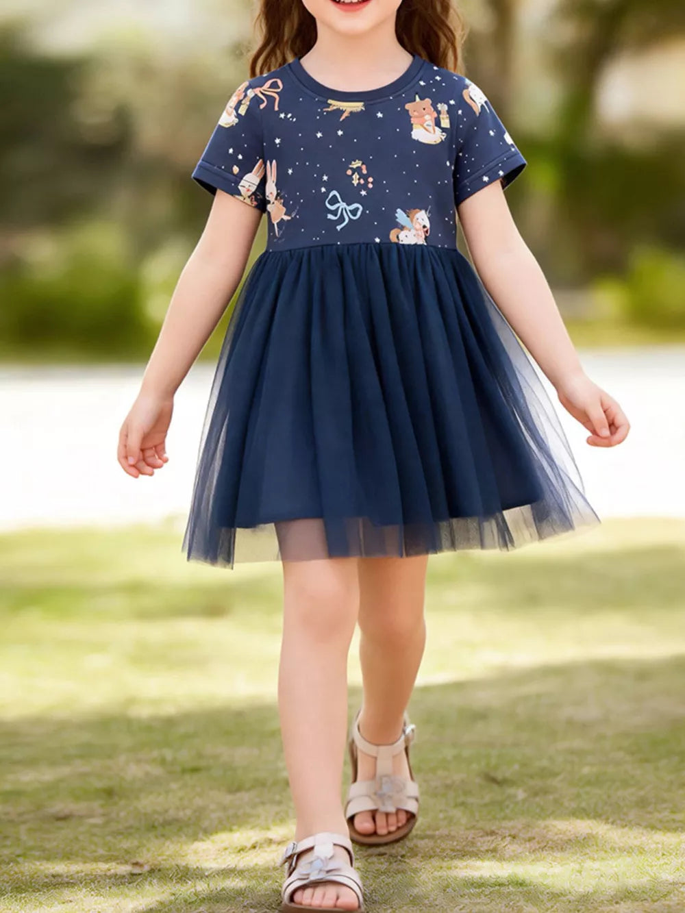 Navy blue tulle dress with short sleeves and a cartoon print featuring animals and stars.