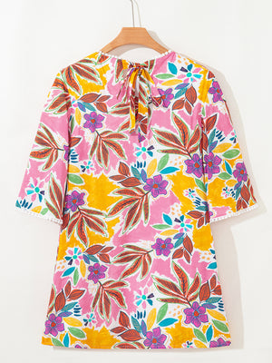Print bell sleeve mini dress with colorful floral pattern and tie back.