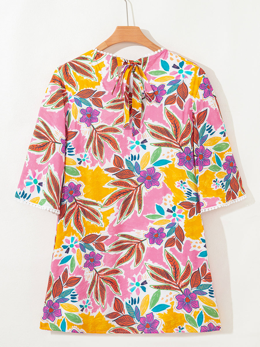 Print bell sleeve mini dress with colorful floral pattern and tie back.