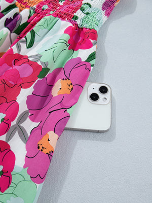 Floral V-neck zip midi dress with smocked bodice and large floral print.