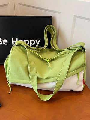 Vibrant color-block nylon travel bag with green and white panels and adjustable strap.