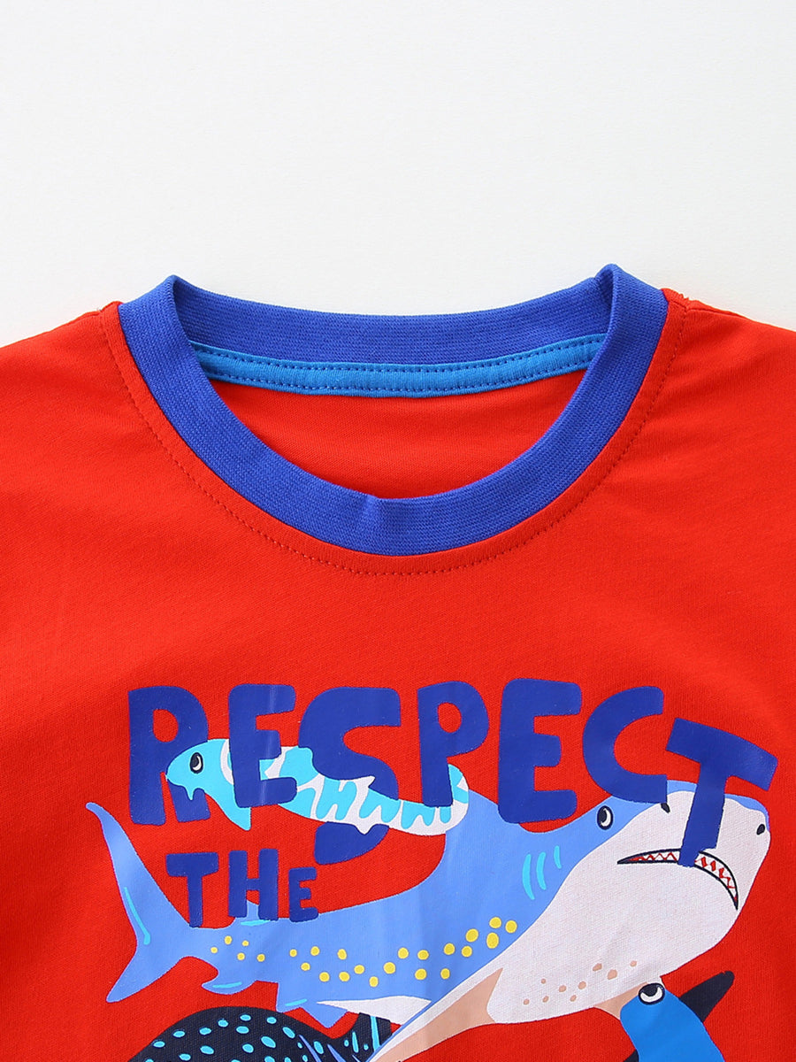 Red children's t-shirt with blue trim and a cartoon shark graphic that says Respect The.