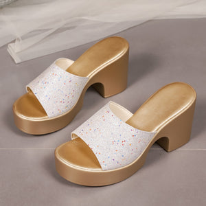White glitter open-toe block heel sandals with gold platform and heel.